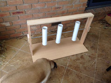 Diy dog toy game for environmental enrichment. Dog hits tubes so they spin and twirl and food ...