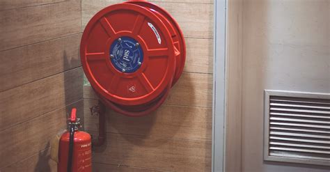 Red Fire Extinguisher Beside Hose Reel Inside the Room · Free Stock Photo