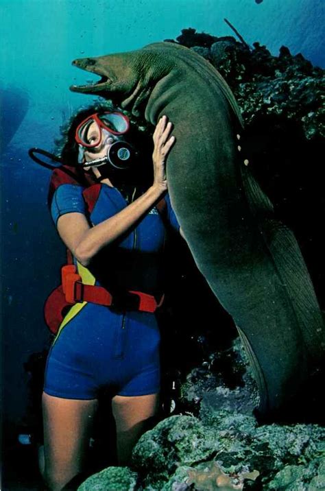 Professional diver with a green moray eel off of the Caymen Islands National Geographic | June ...