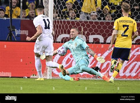 Sweden's goalkeeper Robin Olsen rescues a shot from Slovenia's Benjamin ...