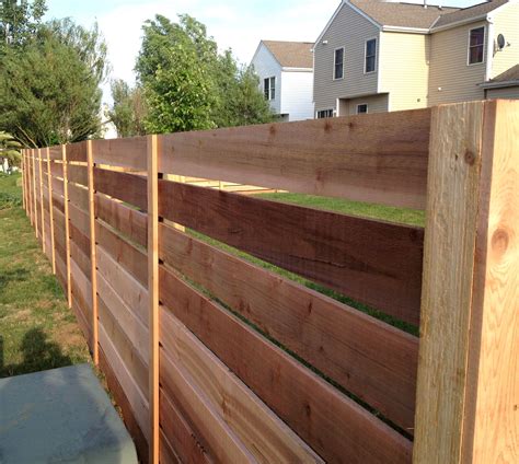 a wooden fence in front of a house