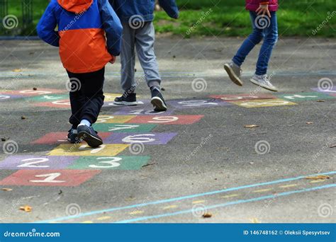 Closeup of Kids Feet Jumping and Playing Hopscotch at School Stock Photo - Image of kids ...