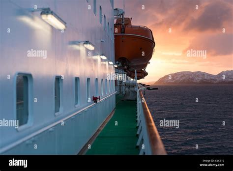 Norway, Finnmark, Kirkenes, sunrise since ship MS Nordkapp company Hurtigruten sails along ...