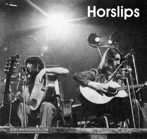 the horslips performing on stage with their guitars in front of microphones