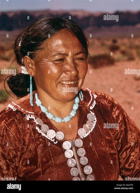 1950s NATIVE AMERICAN NAVAJO INDIAN WOMAN WEARING HAND MADE JEWELRY AND DRESS ADORNED WITH ...