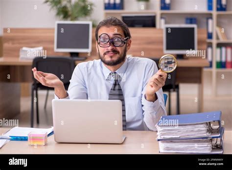 Office work funny young magnifying hi-res stock photography and images ...