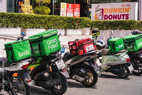 BANGKOK, THAILAND - APRIL 2020 : Various food delivery box on the motorcycles include Grab Food ...