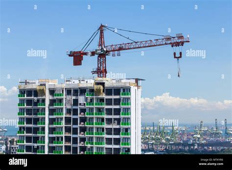 Red colour tower crane against the skyline during the construction ...