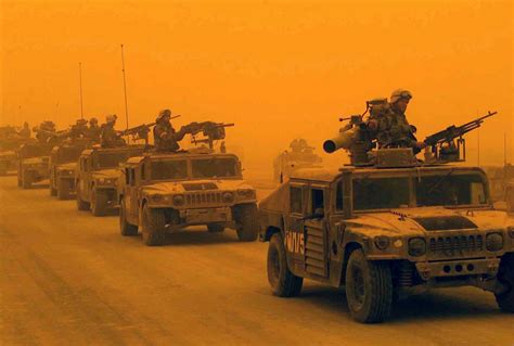 A convoy of U.S. Marine Corps (USMC) High-Mobility Multipurpose Wheeled Vehicles (HMMVW ...