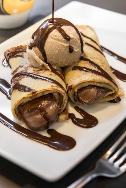 Premium Photo | Chocolate crepe with ice cream on a white plate.