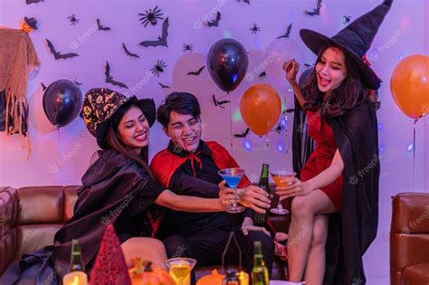 Premium Photo | Asian young people in costumes celebrating halloween group having fun at party ...