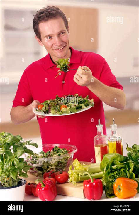 MAN EATING MIXED SALAD Stock Photo - Alamy