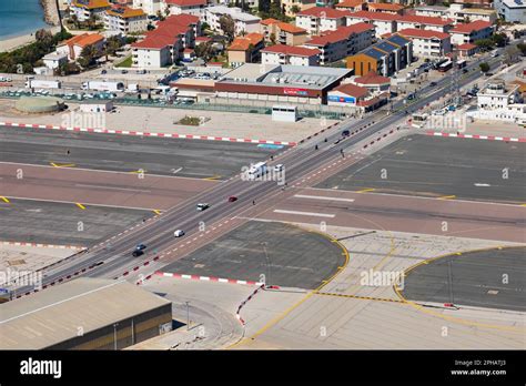 Vehicles cross the main runway of Gibraltar Airport. A tunnel has been proposed by the local ...