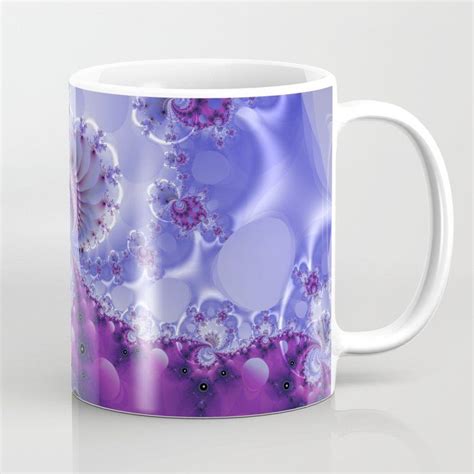 a purple and white coffee mug with flowers on it