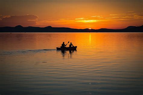 HD wallpaper: 2 Person on Boat Sailing in Clear Water during Sunset, backlit | Wallpaper Flare