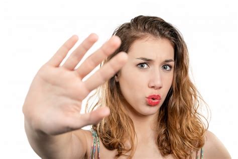 Premium Photo | Portrait of a beautiful girl showing stop sign with palm isolated on a white ...