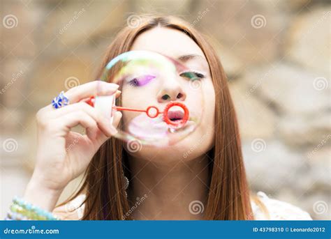 Closeup Portrait of Beautiful Young Woman Inflating Colorful Soap Bubble. Stock Photo - Image of ...