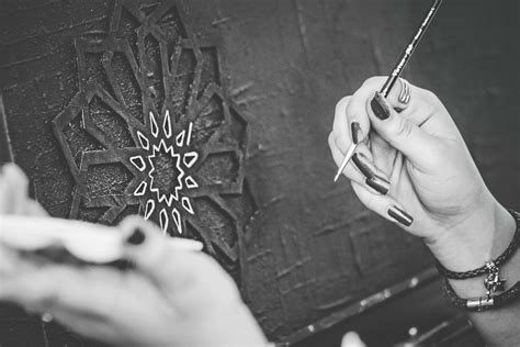 Black and White Photo of Hands Holding a Paintbrush · Free Stock Photo