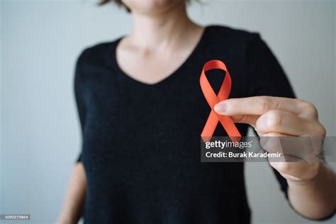 Young Woman With Red Aids Awareness Ribbon High-Res Stock Photo - Getty Images