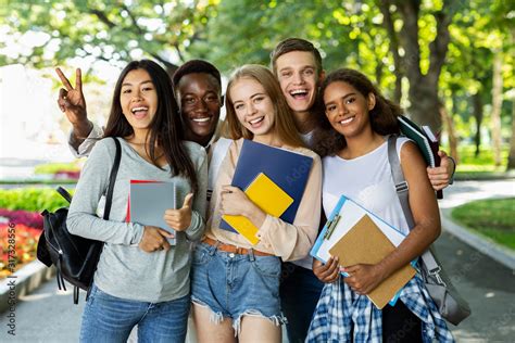 Portrait of international happy students posing in park Stock Photo | Adobe Stock