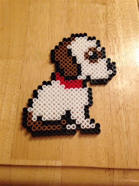 a beaded dog sitting on top of a wooden table