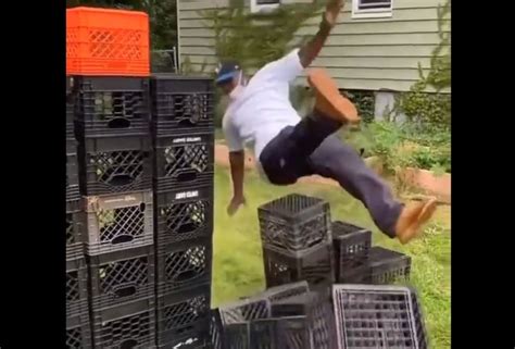 Step by step, the participant walks precariously up a pyramid of milk crates, inching closer to ...