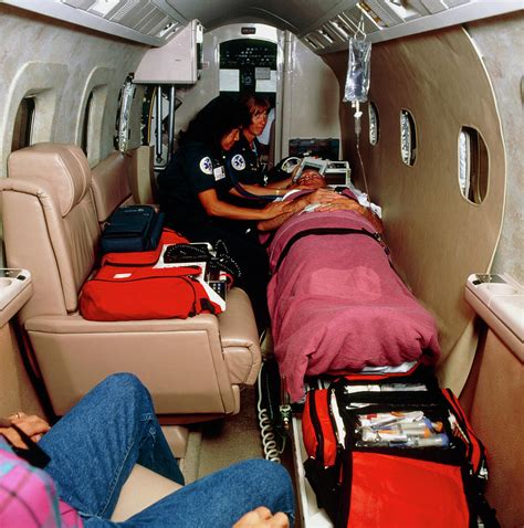 Paramedics With A Patient Inside An Air Ambulance Photograph by Ed ...