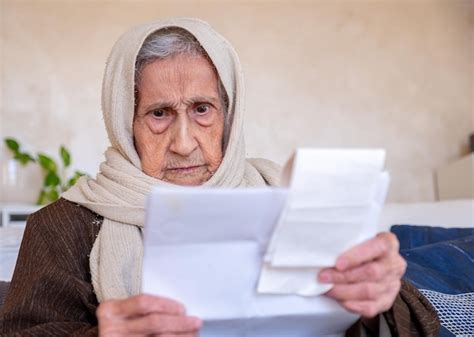 Premium Photo | Old lady holding receipt checking costs of living and house rent and her debts