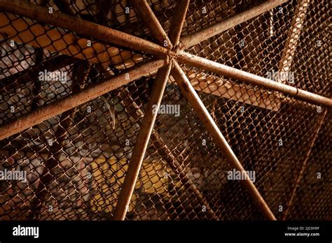 Rusty chain link fence with reinforcement in a ray of sunlight Stock Photo - Alamy