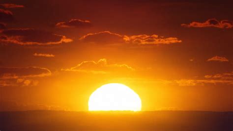 A Time Lapse Of The Large Orange Sunset As The Massive Sun Sets Into ...