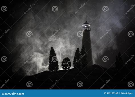 Lighthouse with Light Beam at Night with Fog. Old Lighthouse Standing ...