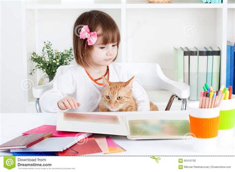 Girl and a Cat Read a Picture Book Stock Photo - Image of activity, floor: 65410730