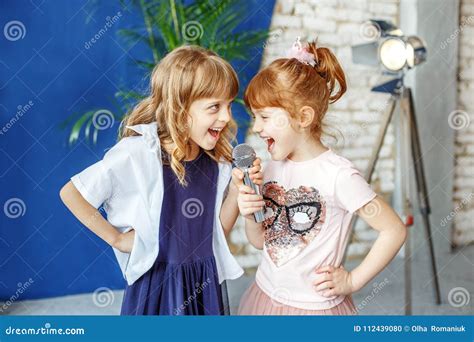 Two Happy Little Children Sing a Song in Karaoke. the Concept is Stock ...