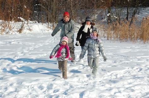 Premium Photo | Happy family walks in winter, having fun and playing ...