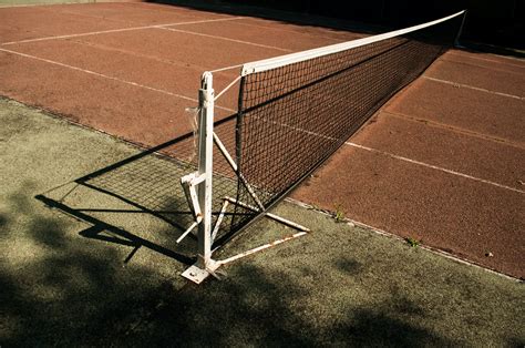 Tennis Ball on Tennis Racket on Floor · Free Stock Photo