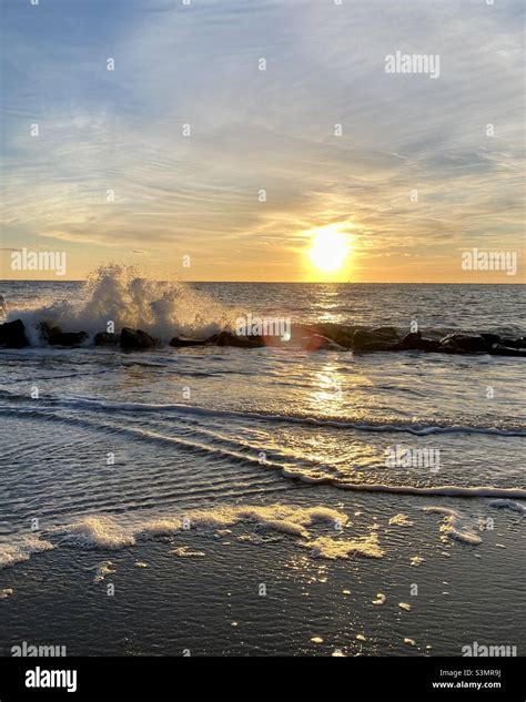 Ocean wave at sunrise Stock Photo - Alamy