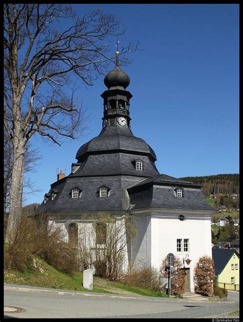 an old building with a clock on the top and steeple at the end, in ...