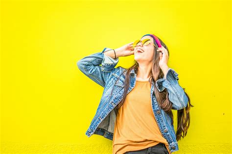 Smiling Woman Looking Upright Standing Against Yellow Wall · Free Stock ...