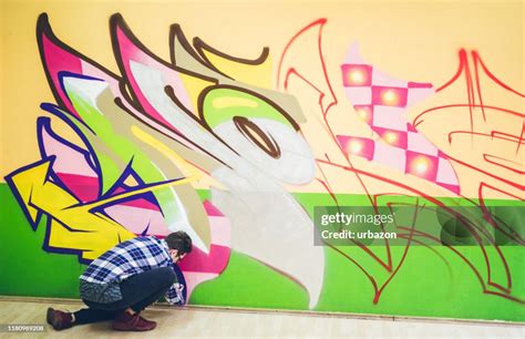 Man Painting Graffiti On Orange Wall High-Res Stock Photo - Getty Images