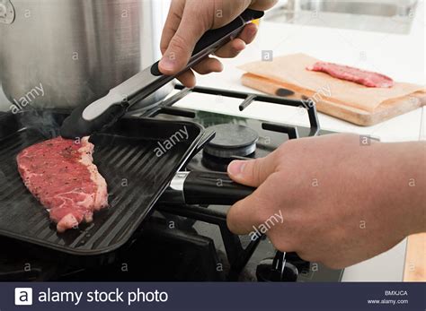 Man cooking steak on griddle Stock Photo, Royalty Free Image: 30088698 ...