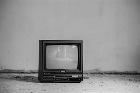 Vintage TV set on floor near wall · Free Stock Photo