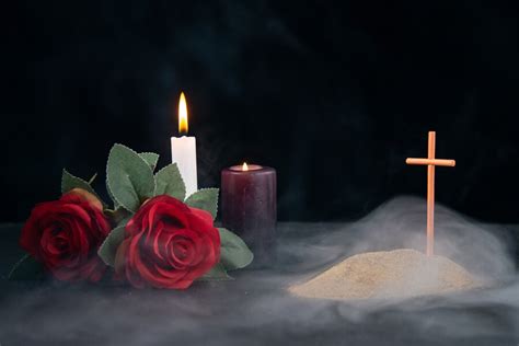 Free Photo | Little grave with candles and flowers as memory on dark ...