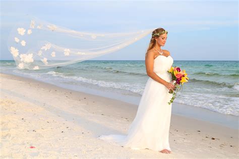 Beautiful bride on the beach in Grayton Beach Florida, long veil and flower crown, photo ...