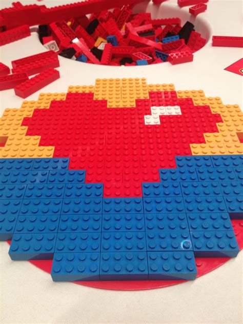 legos laid out on a table with red, yellow and blue blocks in the shape ...