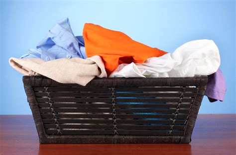 Bright clothes in laundry basket, on color background | Flickr