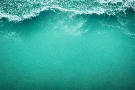 Premium Photo | Turquoise sea wave as it crashes against the coast ...