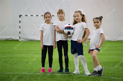 Premium Photo | Children playing football indoors football team ...