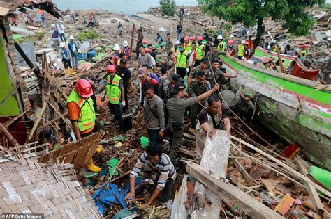 Horrific moment Indonesian tsunami victim is swept away as enormous volcanic wave crashes into ...