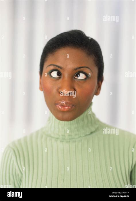 Woman with her eyes crossed and pursed lips Stock Photo - Alamy