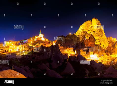 Night scene of the Uchisar Castle in Cappadocia. Illuminated view of famous Uchisar village ...